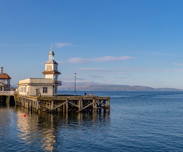 derelict peir with boats sailing away